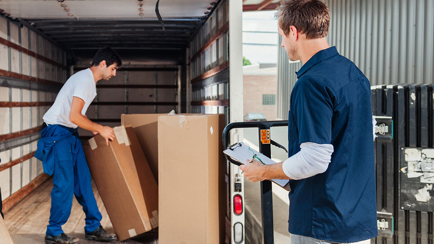 © iStock | Camrocker Workers loading a delivery truck.